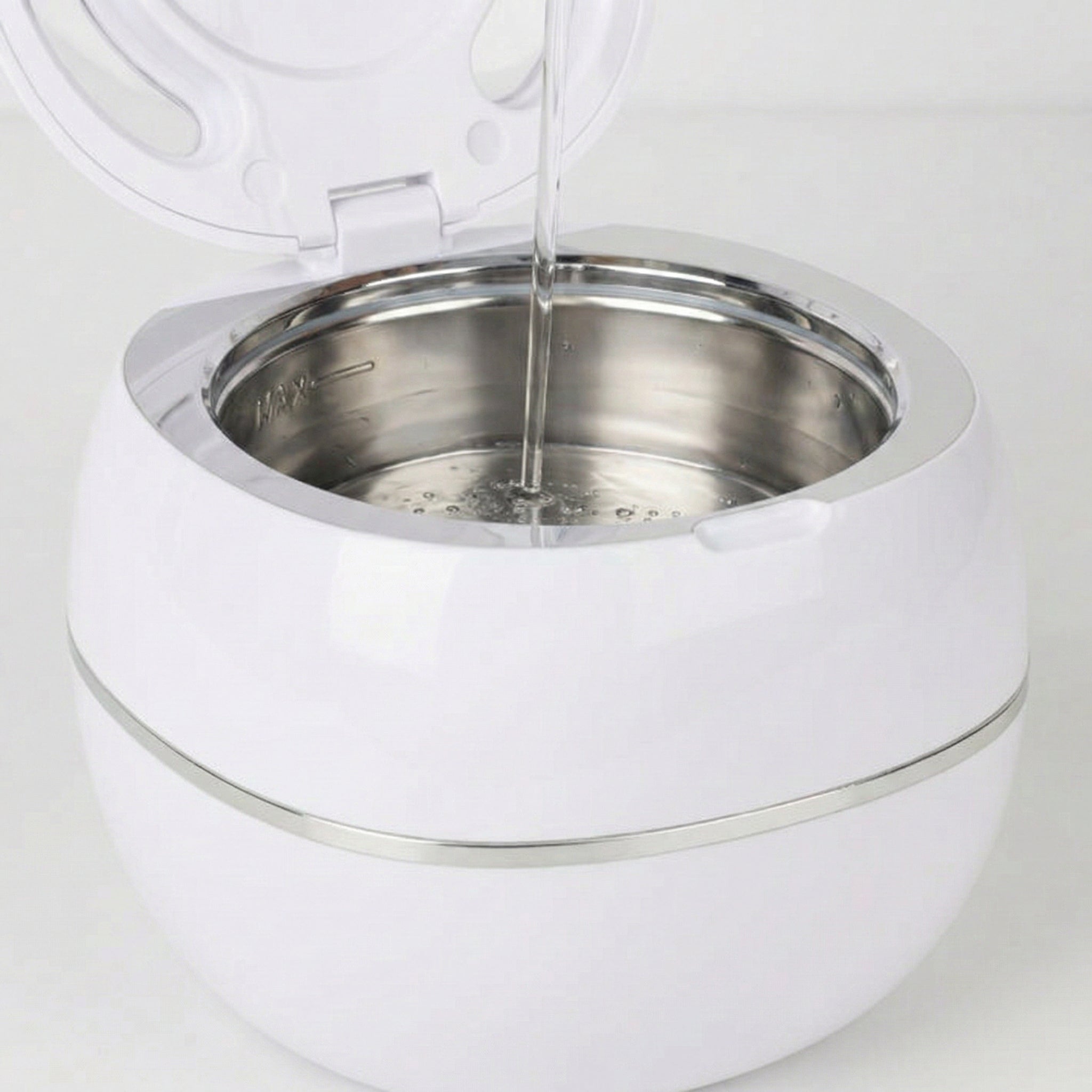 Filling the PureDental Cleaner with water and placing an appliance inside