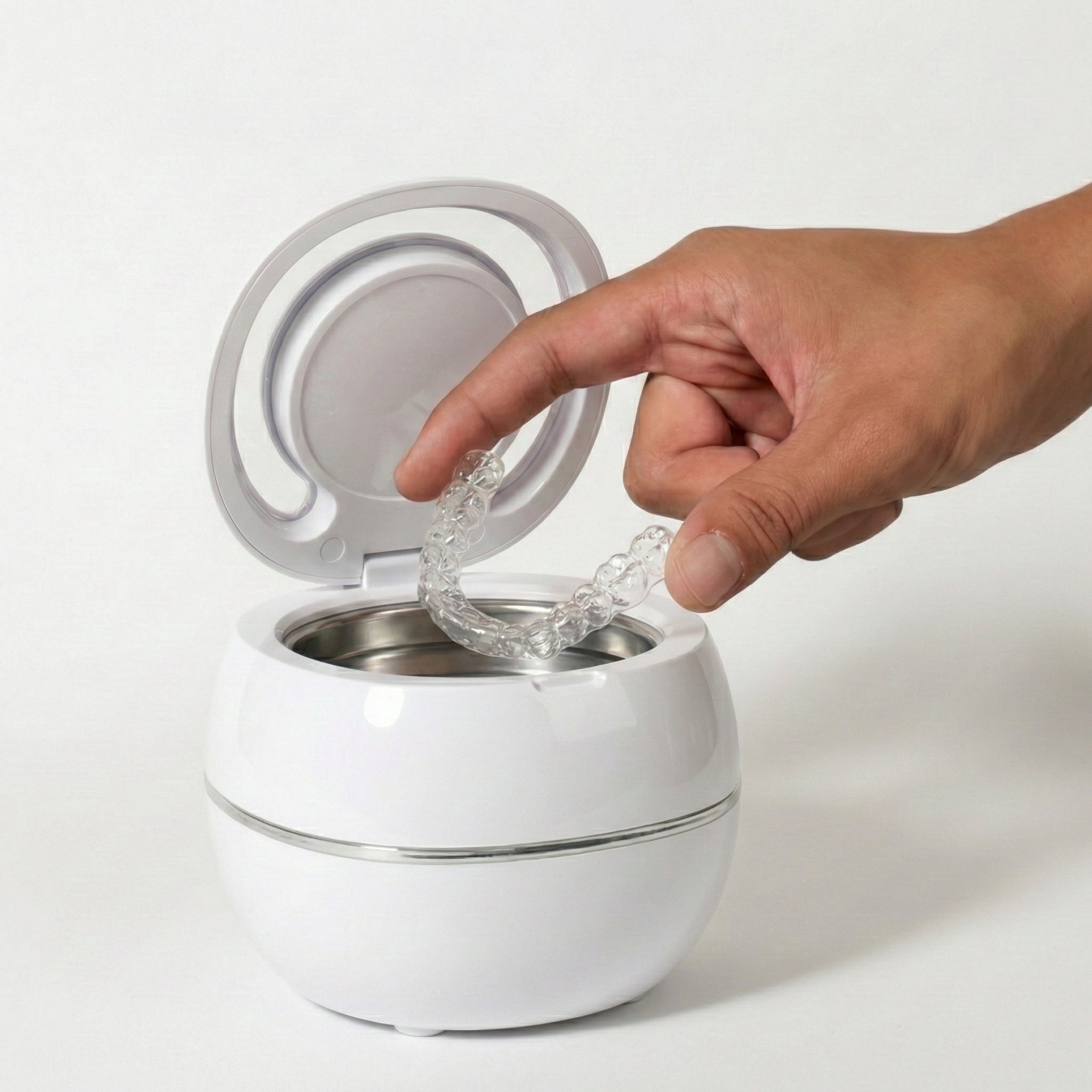 Opening the PureDental Cleaner to take out the clean appliance
