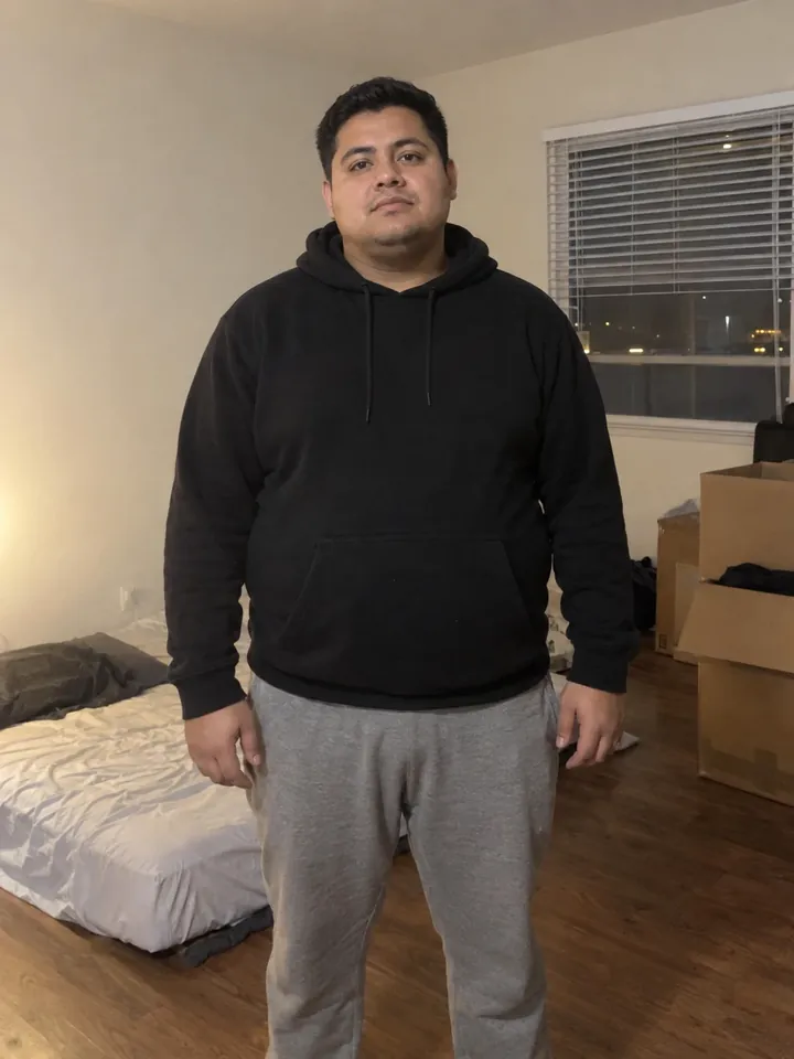 Illustrative before photo: a man in his 20s in his studio apartment