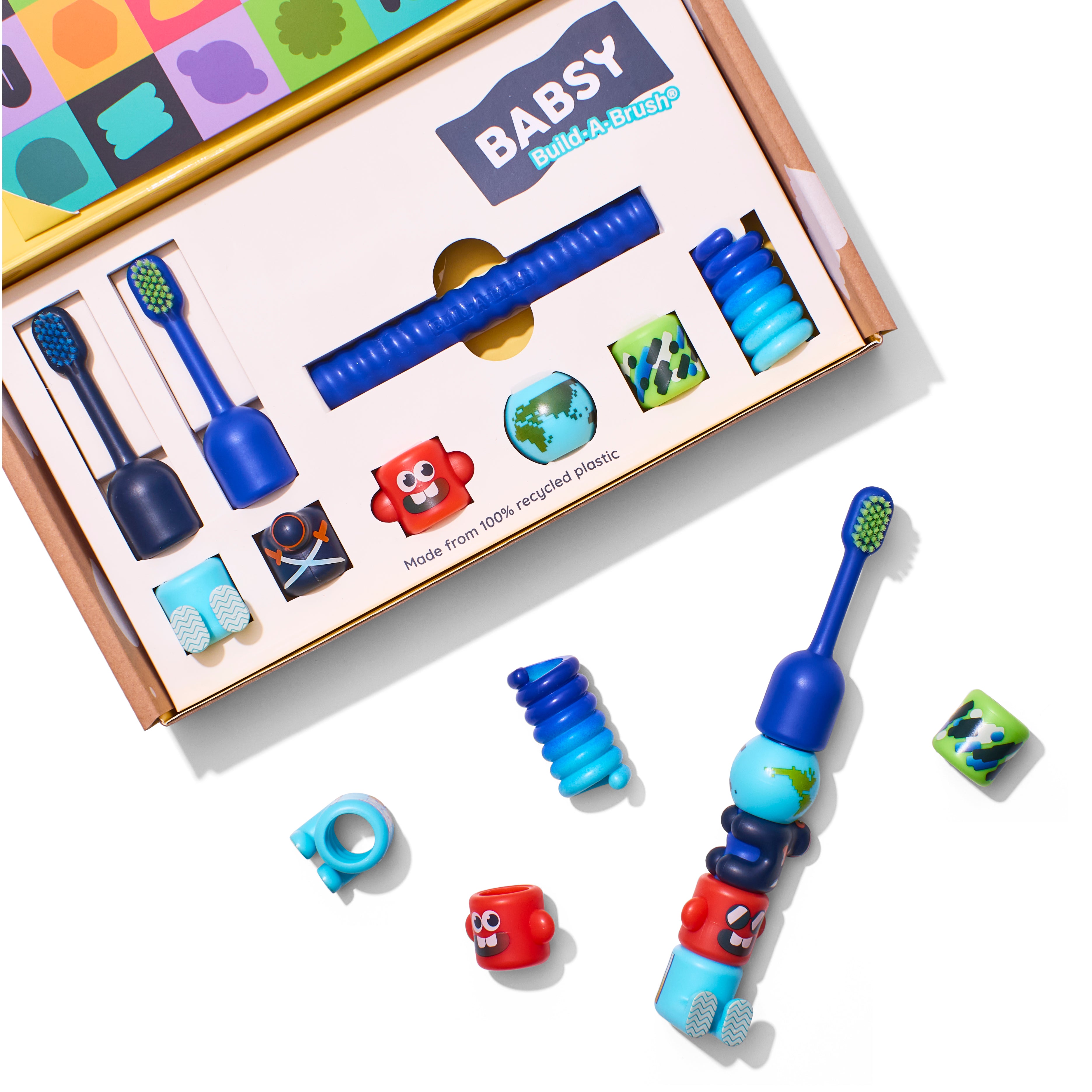 Build-A-Brush Starter Kit box with spiral core, brush heads, and bits